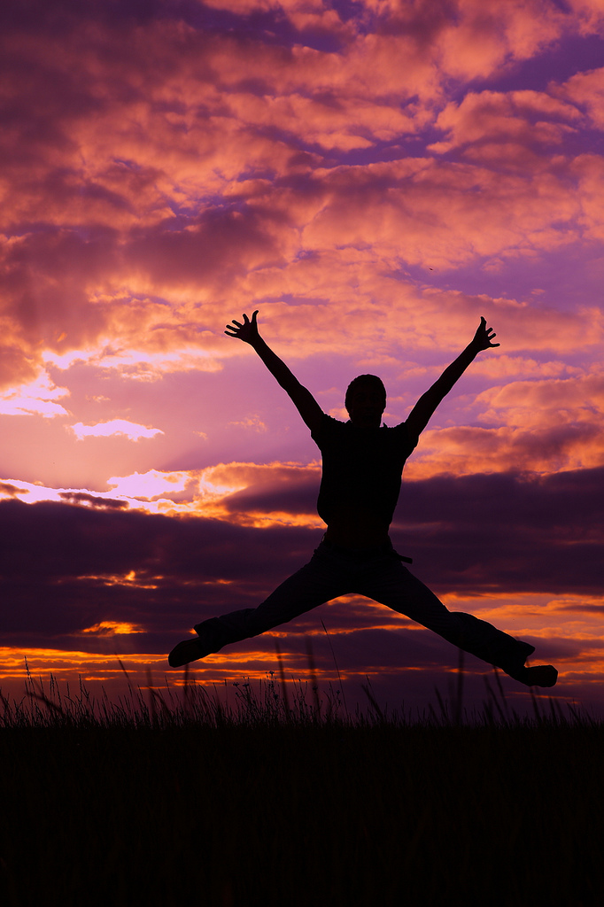 Jumping for joy in sunset